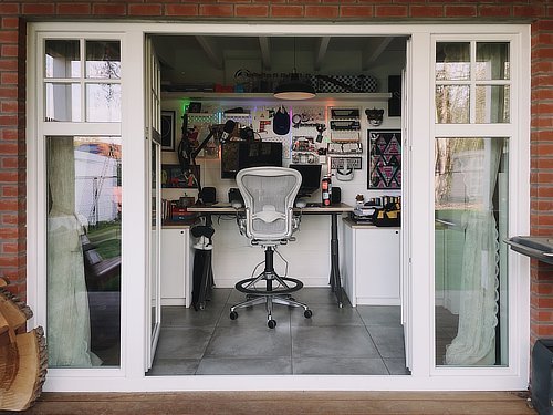 A photo of Tim's desk from the outside looking in through open doors.